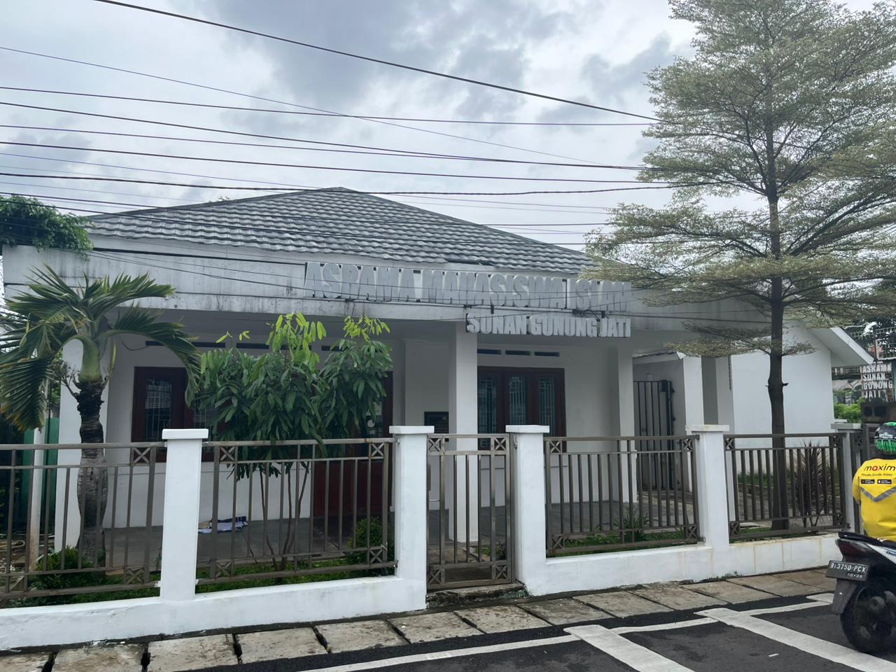 Modern dormitory building exterior with students walking